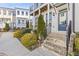 Charming townhome exterior featuring brick steps, manicured landscaping, and a covered porch at 1756 Morningtide Ne Ln, Atlanta, GA 30324