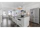 Modern kitchen with stainless steel appliances, oversized island with seating, and hardwood floors at 1756 Morningtide Ne Ln, Atlanta, GA 30324