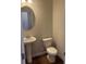 Half bathroom with pedestal sink and mirror in neutral tones at 1857 Kingsmere Run Dr, Loganville, GA 30052