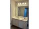 Bathroom with dual sinks, vanity with cabinet, and large mirror at 1857 Kingsmere Run Dr, Loganville, GA 30052