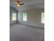 Large bedroom with ceiling fan, carpet and natural light from two windows at 1857 Kingsmere Run Dr, Loganville, GA 30052