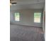 Expansive bedroom with carpeted floors, ceiling fan, and two windows at 1857 Kingsmere Run Dr, Loganville, GA 30052