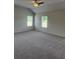 Bright, carpeted bedroom featuring a ceiling fan and inviting natural light at 1857 Kingsmere Run Dr, Loganville, GA 30052
