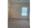 Neutral bedroom featuring a window with blinds and plush carpet at 1857 Kingsmere Run Dr, Loganville, GA 30052