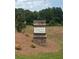 The Kingsmere Estates community sign is set among a beautifully landscaped entrance at 1857 Kingsmere Run Dr, Loganville, GA 30052