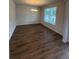 Dining room features wood-look floors, chandelier, and plenty of natural light at 1857 Kingsmere Run Dr, Loganville, GA 30052
