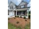Two-story home with brick facade, a two-car garage, and manicured landscaping at 1857 Kingsmere Run Dr, Loganville, GA 30052