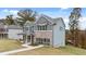 Charming two-story home with brick accents, gray siding and well-manicured lawn at 1857 Kingsmere Run Dr, Loganville, GA 30052