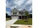 Two-story home with brick facade, a two-car garage, and well-manicured lawn at 1857 Kingsmere Run Dr, Loganville, GA 30052