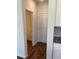 Hallway with hardwood floors leading to additional rooms and storage space at 1857 Kingsmere Run Dr, Loganville, GA 30052