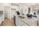 Charming kitchen with granite countertops, stainless steel appliances, white cabinets and functional island with seating at 1857 Kingsmere Run Dr, Loganville, GA 30052