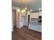 Modern kitchen with white cabinets, granite countertops, and a stylish chandelier at 1857 Kingsmere Run Dr, Loganville, GA 30052