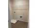 Functional laundry room features tiled floors, utility sink, and washer-dryer hookups at 1857 Kingsmere Run Dr, Loganville, GA 30052