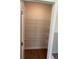 Walk-in pantry with shelving for ample storage and hardwood floors at 1857 Kingsmere Run Dr, Loganville, GA 30052