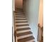 Staircase features wood treads with white risers and a wood handrail at 1857 Kingsmere Run Dr, Loganville, GA 30052