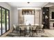 Elegant dining room featuring a modern chandelier, neutral-toned decor, and large windows for natural light at 4250 Carmain Ne Dr, Atlanta, GA 30342