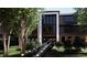 Modern home with beautiful landscaping and a walkway with lights, showcasing a grand entrance with large windows at 4250 Carmain Ne Dr, Atlanta, GA 30342