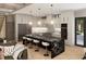 Modern kitchen featuring a large island with seating, stainless steel appliances, and contemporary lighting fixtures at 4250 Carmain Ne Dr, Atlanta, GA 30342
