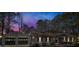 A serene evening shot showcasing a charming home with a detached garage at 2401 Phillips Rd, Lithonia, GA 30058