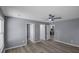 Open-concept living room with wood floors and neutral paint. Multiple door openings visible at 2401 Phillips Rd, Lithonia, GA 30058