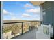 This balcony features glass railings and outdoor seating with an overlook of treetops and the city at 3630 Peachtree Ne Rd # 1809, Atlanta, GA 30326