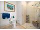 A bathroom features a glass shower, a toilet, and a towel rack with blue towels with neutral wall color at 3630 Peachtree Ne Rd # 1809, Atlanta, GA 30326