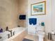 This bathroom features a soaking tub, a toilet, neutral wall color, and blue towels on the towel rack at 3630 Peachtree Ne Rd # 1809, Atlanta, GA 30326