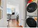 A stacked washer and dryer are located near the entrance to a living room with lots of natural light at 3630 Peachtree Ne Rd # 1809, Atlanta, GA 30326