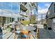 Outdoor kitchen with a built-in grill, dining table, and views of a modern high-rise at 3630 Peachtree Ne Rd # 1809, Atlanta, GA 30326