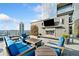 Outdoor patio with a fireplace, TV, comfortable seating, and scenic city views at 3630 Peachtree Ne Rd # 1809, Atlanta, GA 30326