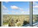 Breathtaking views from a large window overlooking a forest canopy at 3630 Peachtree Ne Rd # 1809, Atlanta, GA 30326