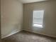 A cozy bedroom with neutral carpet, light walls, and a window at 266 Valley Xing, Canton, GA 30114