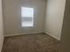 A cozy bedroom with neutral carpet, light walls, and a window at 266 Valley Xing, Canton, GA 30114