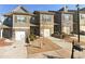 Attractive townhome exterior boasts stone accents, individual driveways, and inviting curb appeal at 266 Valley Xing, Canton, GA 30114