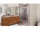 Bathroom featuring a shower, light vanity and decorative mirror at 3782 Chattahoochee Summit Se Dr, Atlanta, GA 30339