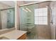 Shower featuring glass doors, tile surround and shower head at 3782 Chattahoochee Summit Se Dr, Atlanta, GA 30339