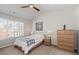Bedroom with a ceiling fan, a window with shutters and a wood dresser at 3782 Chattahoochee Summit Se Dr, Atlanta, GA 30339
