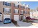 Charming brick townhome with a well-manicured front yard and driveway with cars at 3782 Chattahoochee Summit Se Dr, Atlanta, GA 30339