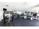 Home gym with mirrored wall, rubber floor and ceiling fans, stocked with multiple workout machines at 3782 Chattahoochee Summit Se Dr, Atlanta, GA 30339