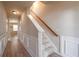 Hallway featuring wood floors, paneled walls, staircase, and natural light at 3782 Chattahoochee Summit Se Dr, Atlanta, GA 30339