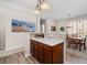 Open kitchen and dining area with wood floors, ample seating, modern appliances, and bar height counter at 3782 Chattahoochee Summit Se Dr, Atlanta, GA 30339