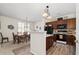 Kitchen and dining area with dark wood cabinets, wood floors, modern appliances, and ample seating at 3782 Chattahoochee Summit Se Dr, Atlanta, GA 30339