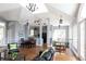 Open-concept living area with grey walls, hardwood flooring, skylight, and access to both the kitchen and outdoors at 3782 Chattahoochee Summit Se Dr, Atlanta, GA 30339