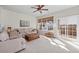 Bright living room featuring a ceiling fan, neutral paint, and sliding doors to an outdoor deck at 3782 Chattahoochee Summit Se Dr, Atlanta, GA 30339