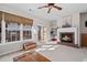 Cozy living room featuring a fireplace, large windows, and sliding doors to an outdoor deck at 3782 Chattahoochee Summit Se Dr, Atlanta, GA 30339