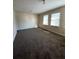 Large bedroom featuring carpet flooring and a light, airy ambiance from the windows at 657 Stratford Green Way, Avondale Estates, GA 30002