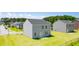 Grassy backyard with view of other homes in neighborhood at 300 Halibut Circle Cir, Covington, GA 30016