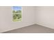 A bright bedroom with carpet flooring, a window view, and white walls at 300 Halibut Circle Cir, Covington, GA 30016