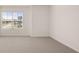 A bright bedroom with carpet flooring, a window view, and white walls at 300 Halibut Circle Cir, Covington, GA 30016