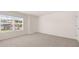 A bright bedroom with carpet flooring, a window view, and white walls at 300 Halibut Circle Cir, Covington, GA 30016